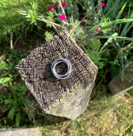 A sterling silver russian wedding ring with a hammered band.