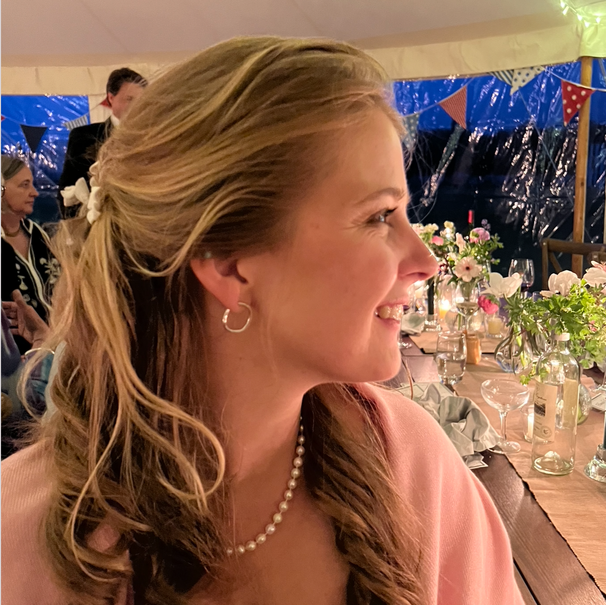 Handmade sterling silver irregular hoop earrings on a model.