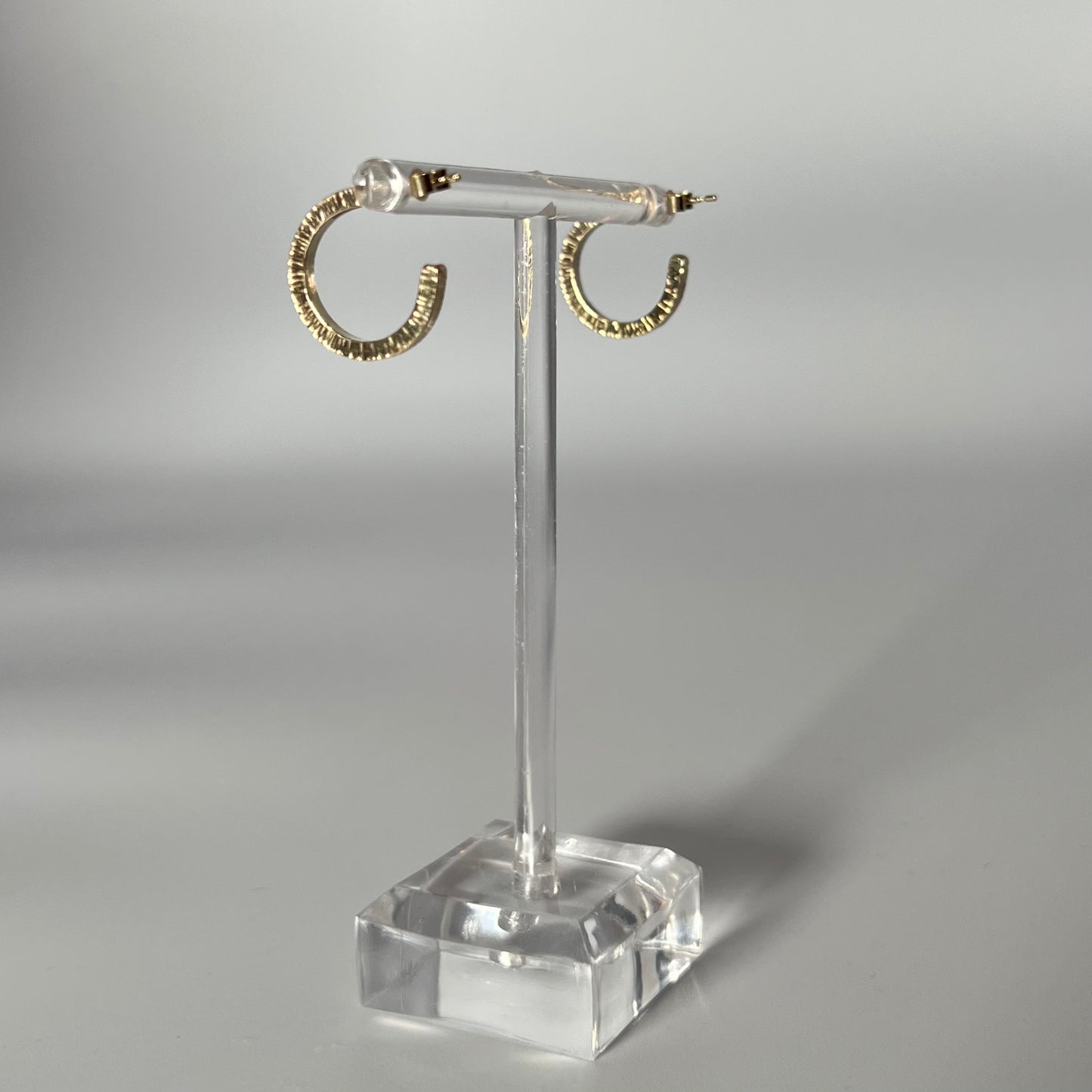Handmade, solid 9ct gold hoop earrings with a lined hammer texture.