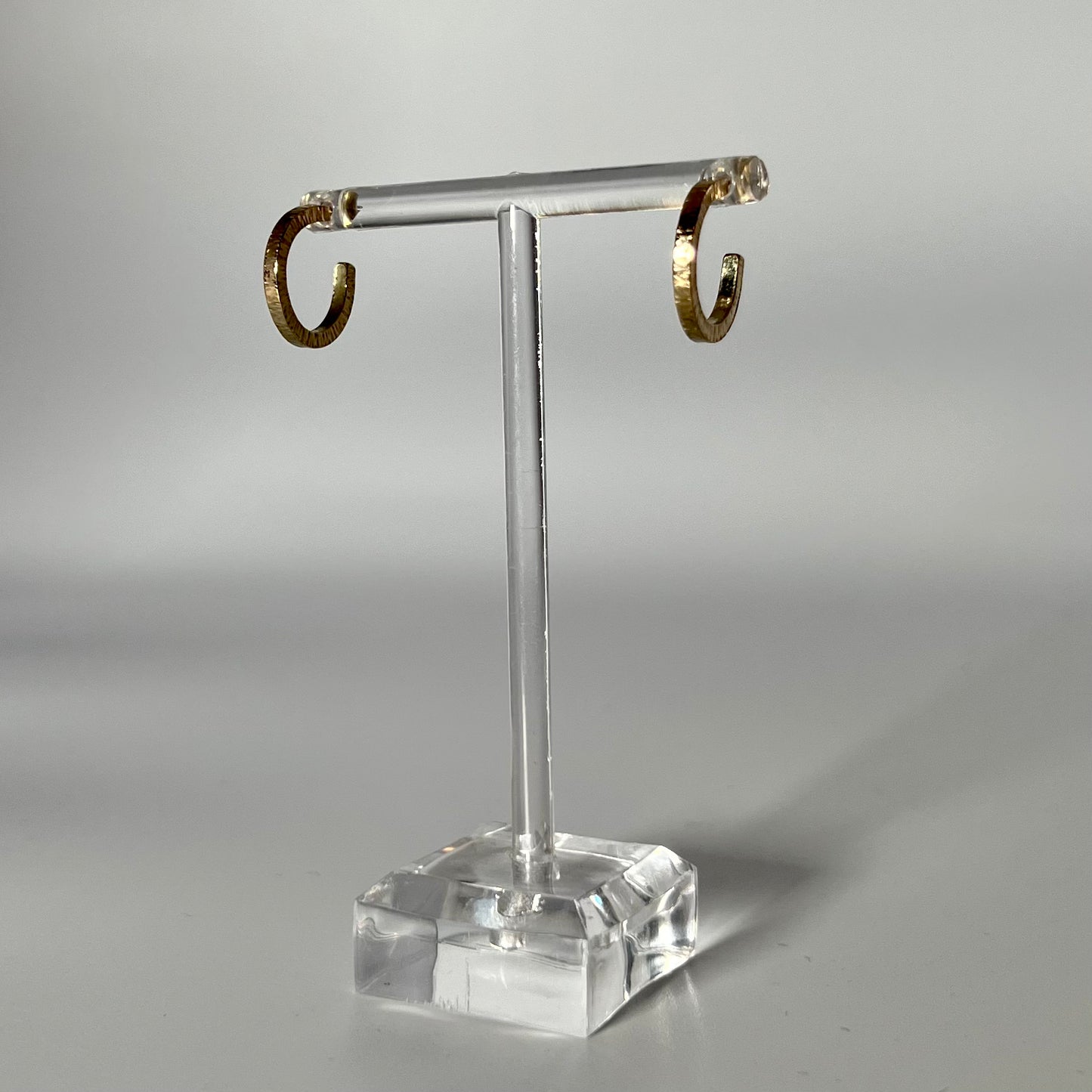 Handmade, solid 9ct gold hoop earrings with a lined hammer texture.