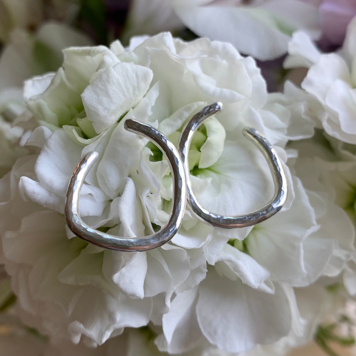Handmade sterling silver irregular hoop earrings.