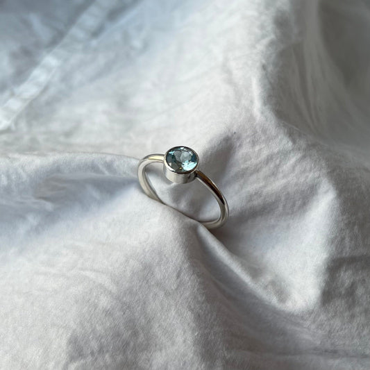A round sparkly aquamarine set in sterling silver