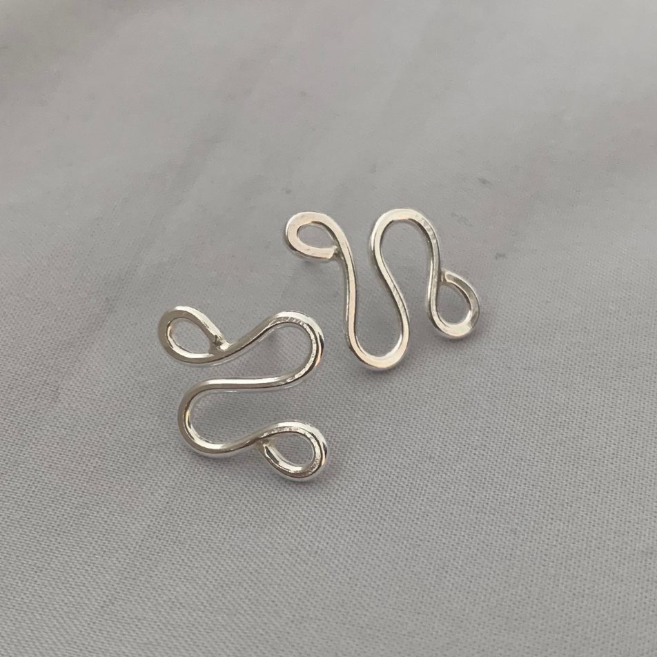 Handmade, sterling silver earrings in a unique ripple shape.