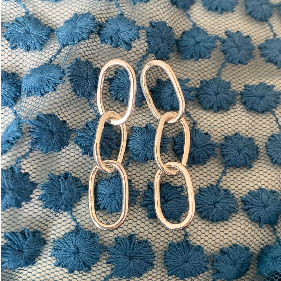 Sterling silver oval pastille triple-chain link earrings.
