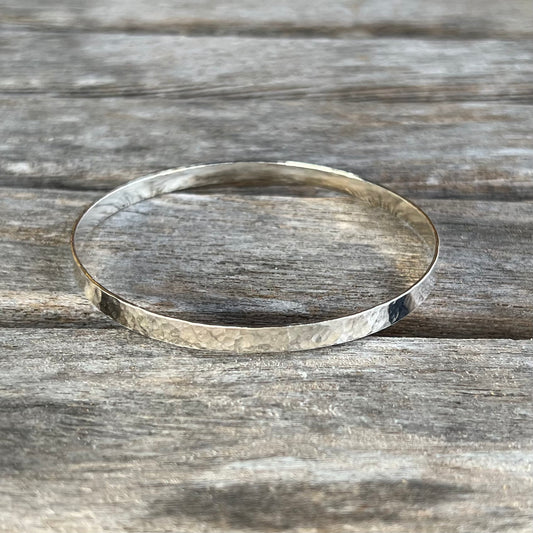 A hammered sterling silver bangle.