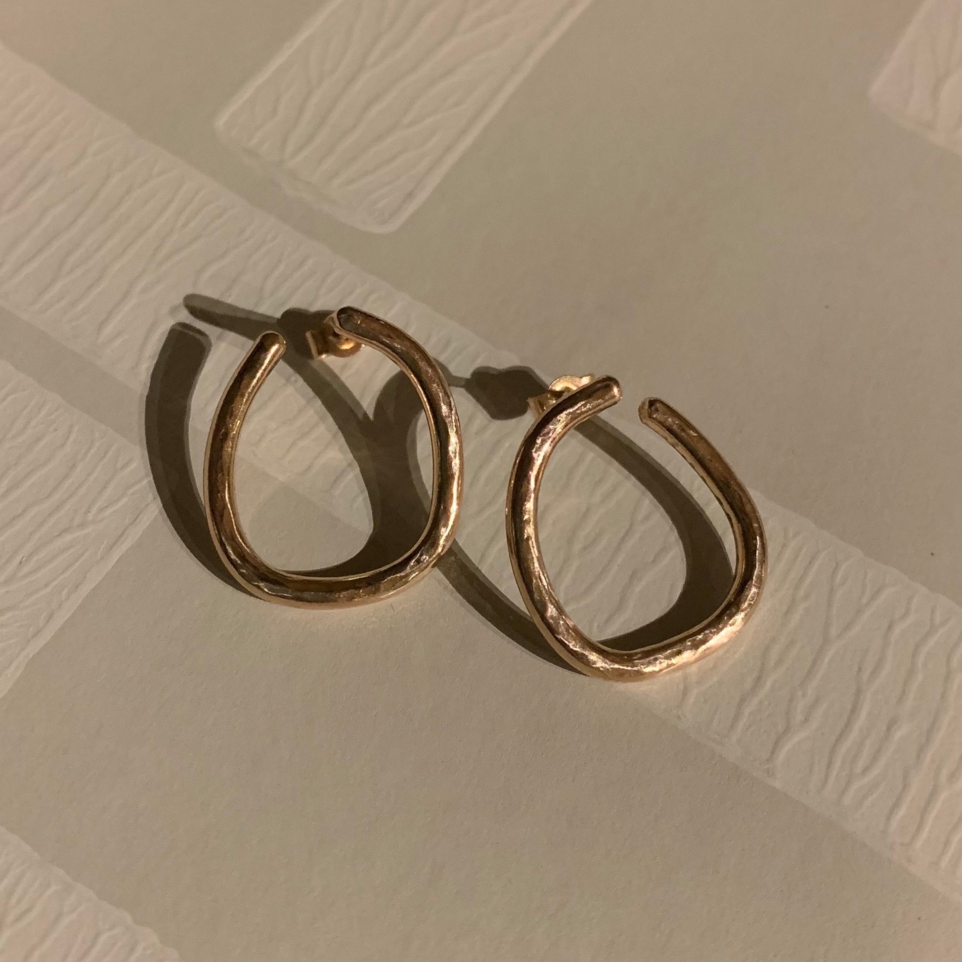 Handmade 9ct rose gold irregular hoop earrings.