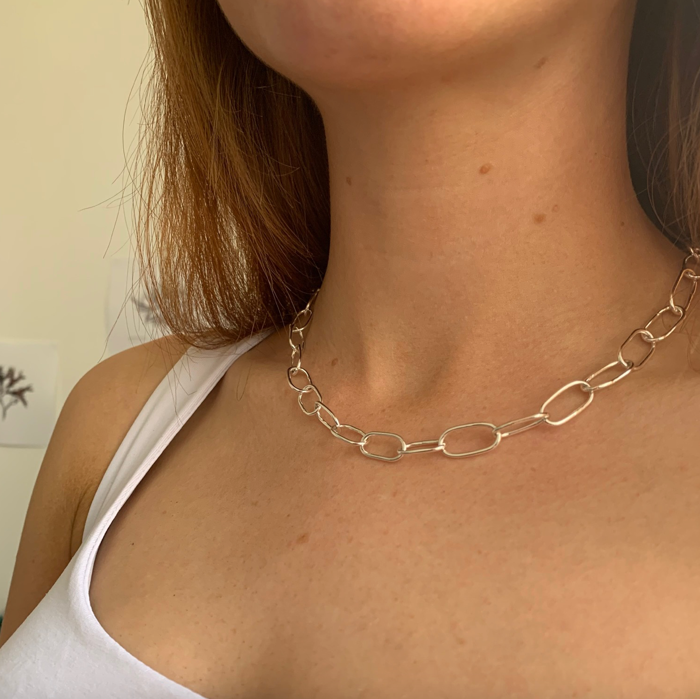 The pastille chain necklace, handmade from sterling silver oval links. Pictured on a model.