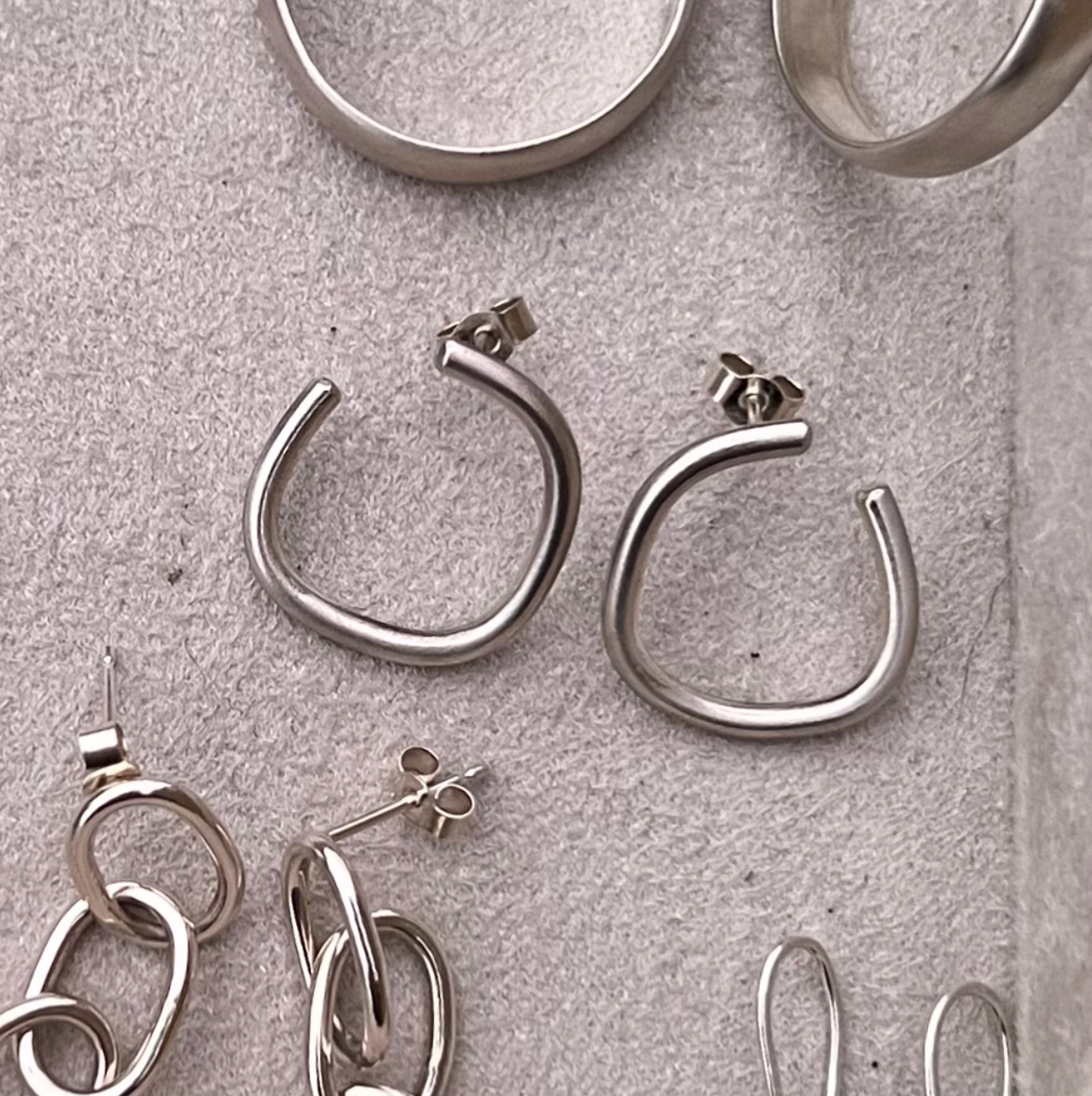 Handmade sterling silver irregular hoop earrings.
