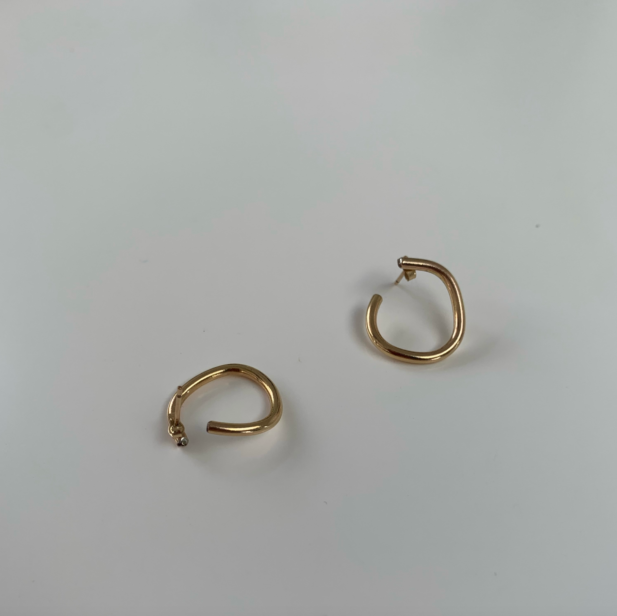 Handmade gold irregular hoop earrings.