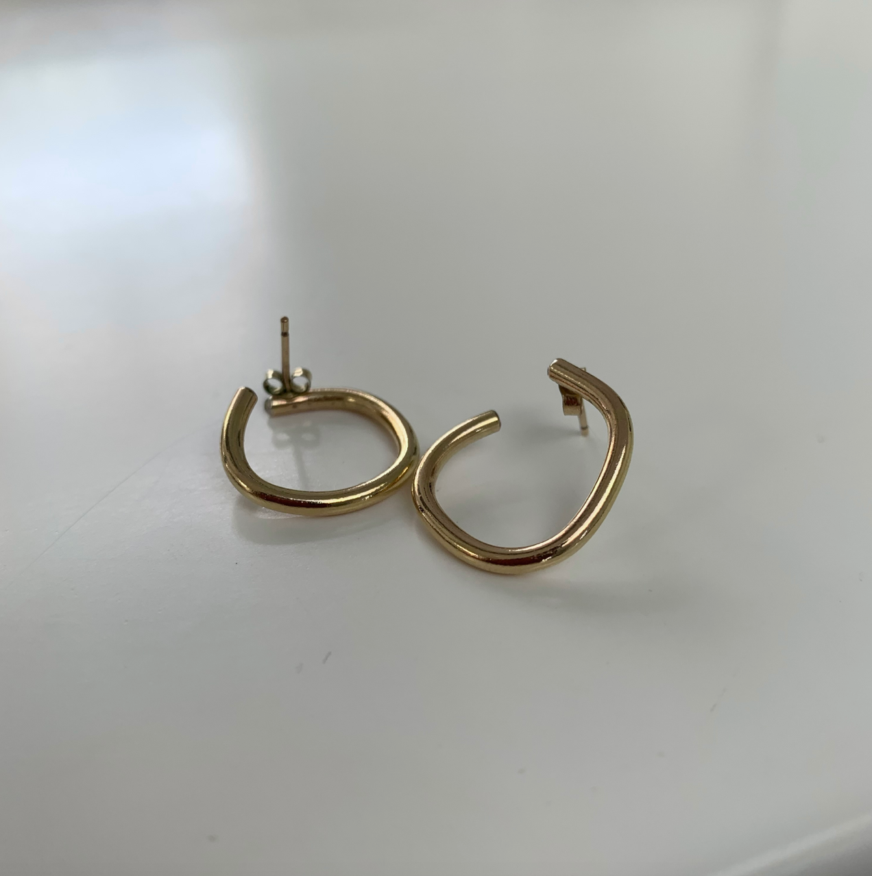 Handmade gold irregular hoop earrings.