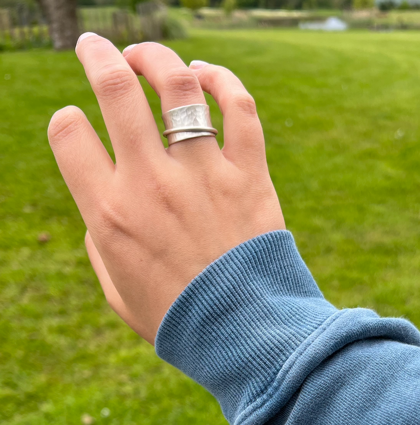 A matt sterling silver spinner ring with one silver spinning band.