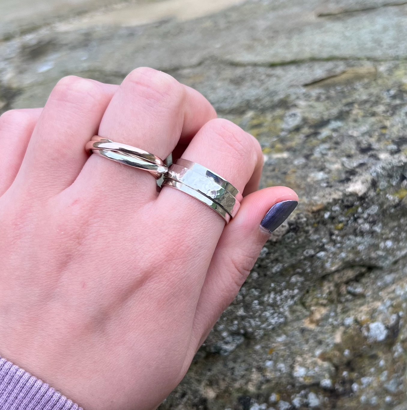 A sterling silver spinner ring with one thick silver spinning band.