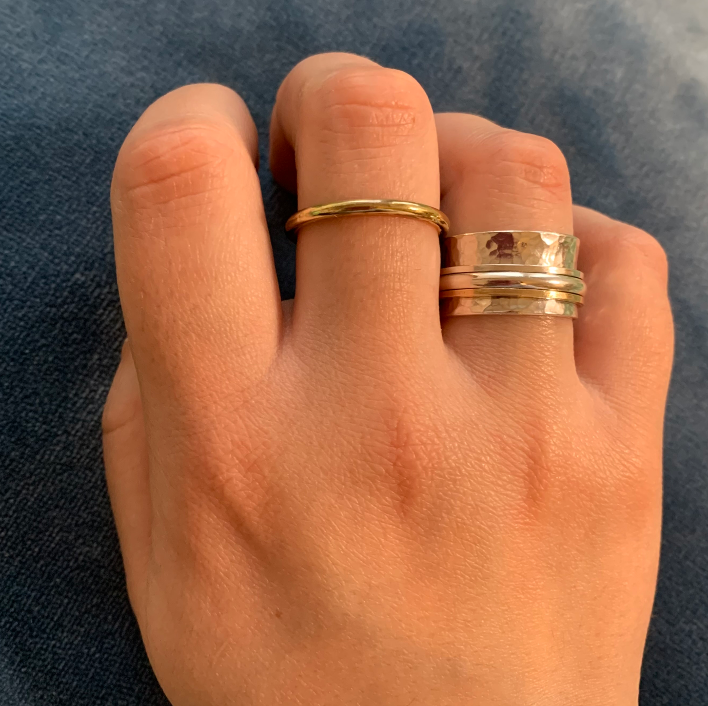 A sterling silver spinner ring with one 9ct gold band and two silver spinning bands.