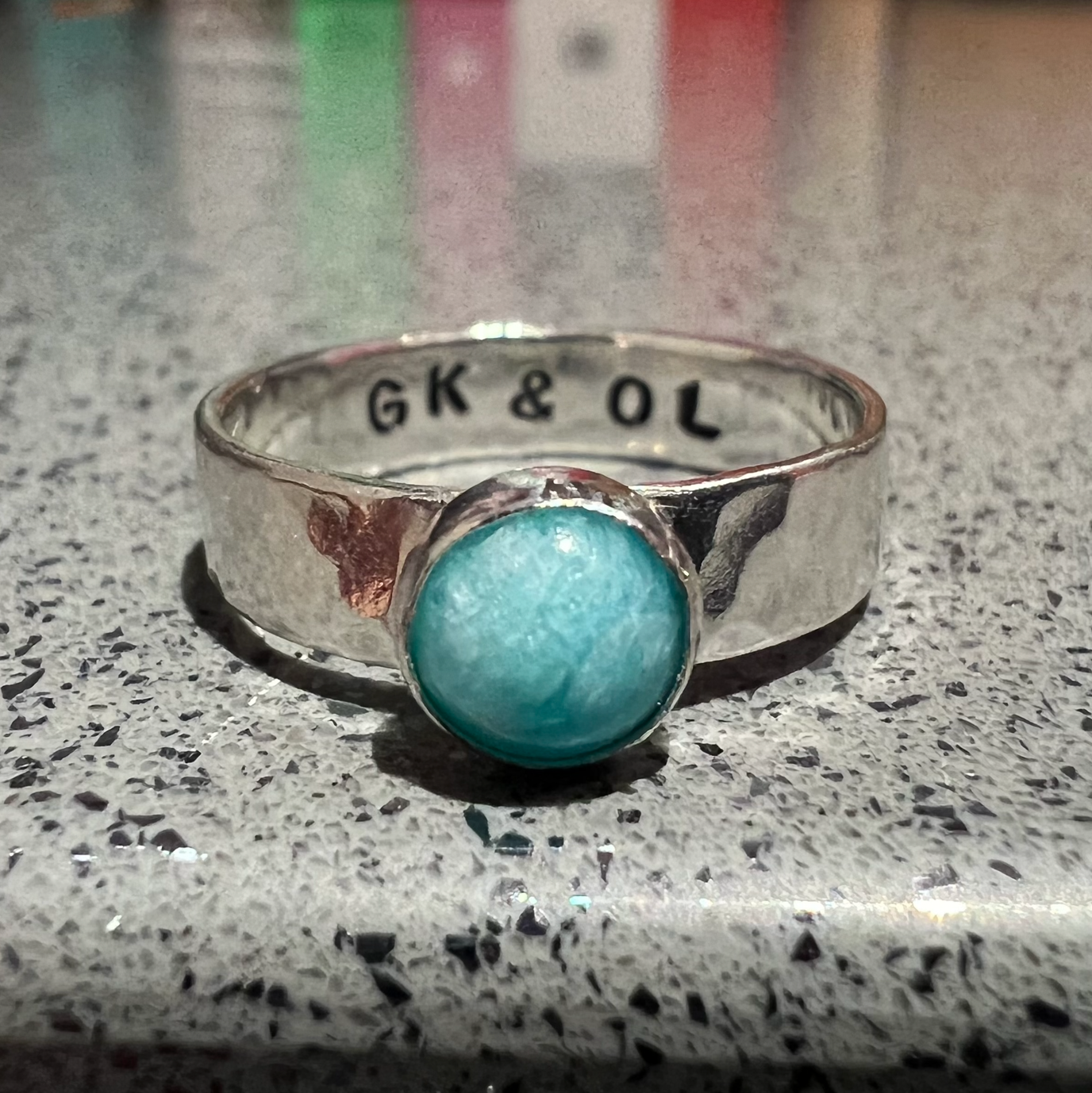 Small round gemstone ring with engraving