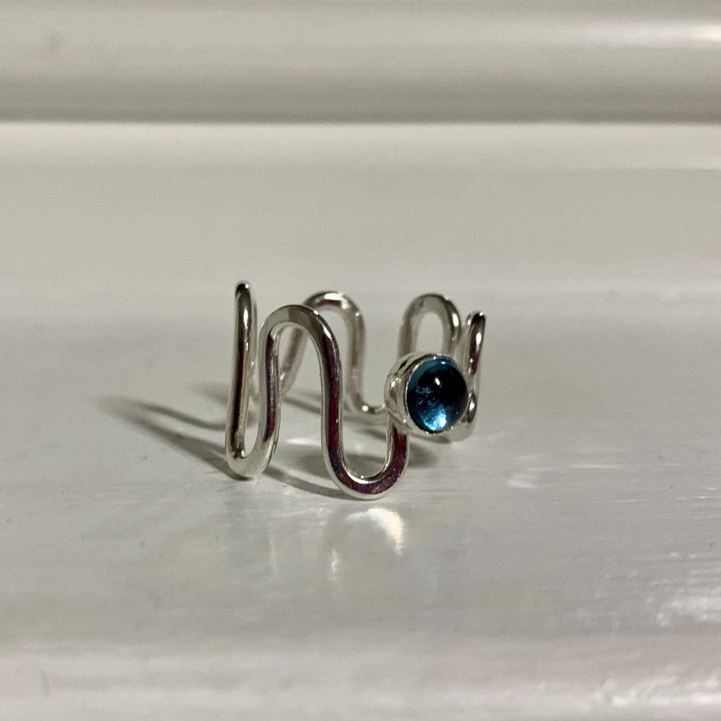 A London blue topaz and sterling silver ripple ring